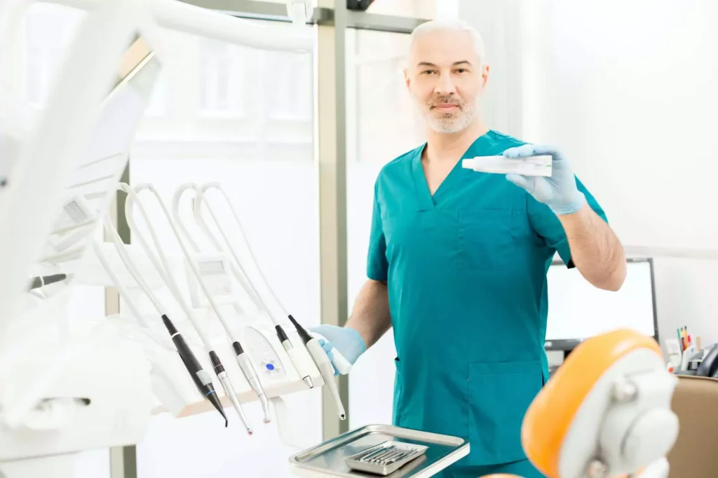 Dentist Showing Toothpaste