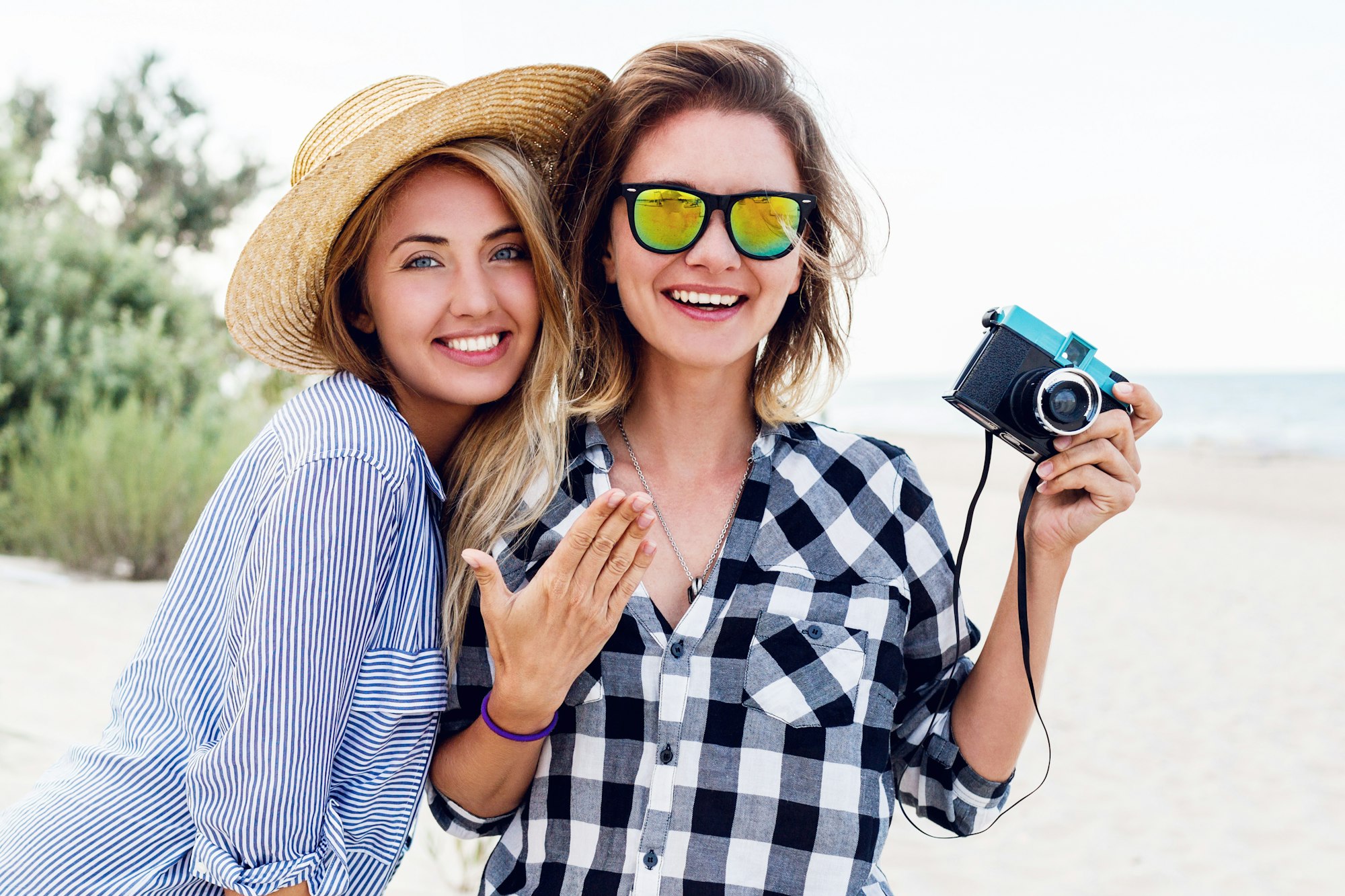 Close up summer lifestyle portrait of two cute women